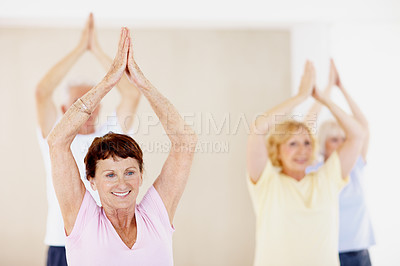 Buy stock photo Hands together, pilates and stretching with senior woman in studio for fitness, health or wellness. Exercise, group and smile with old people in gym class for activity, retirement or training