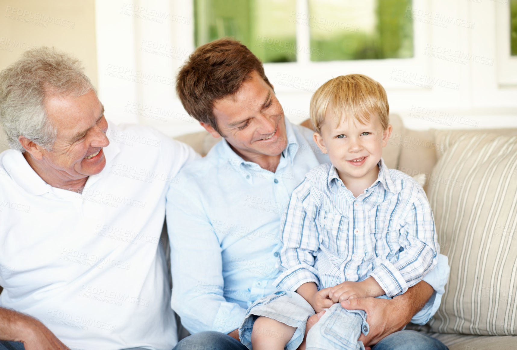 Buy stock photo Old man, laugh and dad with child in lounge, bonding and connection with grandchild on couch in home. Family, generations and happy people with kid, portrait and fathers day celebration in house
