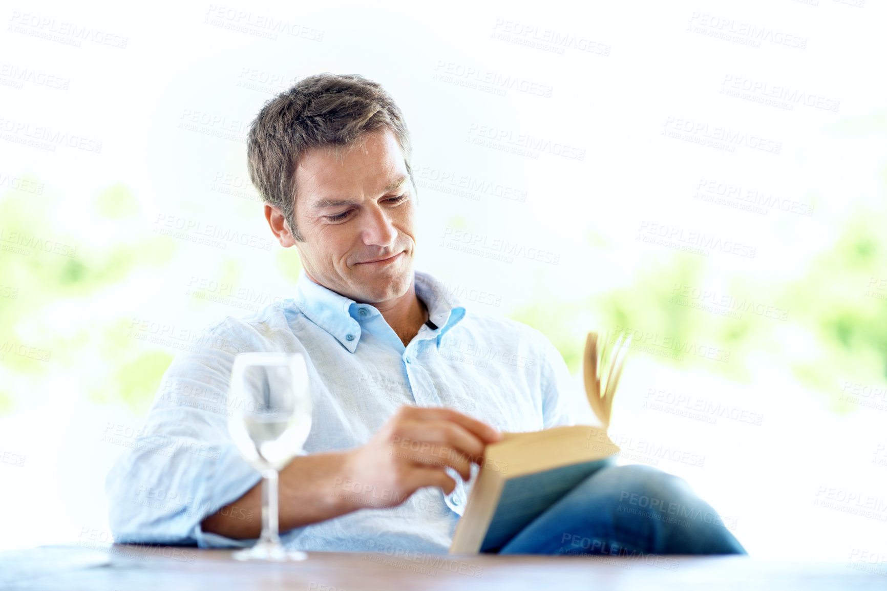 Buy stock photo Reading, story and happy man with wine glass on break, knowledge and chill with book and literature. Fiction, reader and person with alcohol on weekend, smile and relax with novel or entertainment