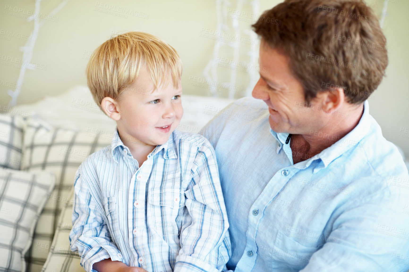 Buy stock photo Family, bonding and dad with child in house, affection and connection with son on weekend or support. Happy man, home and fathers day celebration with kid on couch, love and person with boy on break