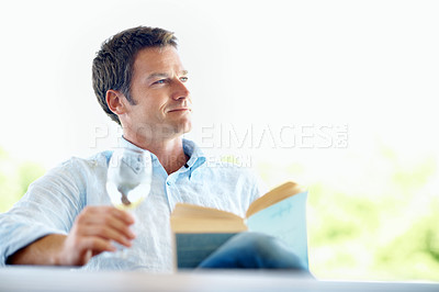 Buy stock photo Book, knowledge and happy man with wine glass, thinking and relax with novel and literature on break. Fiction, reader and person with alcohol on weekend, smile and chill with story or reflection