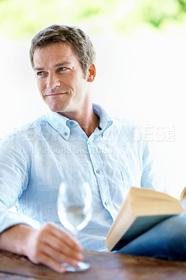 Buy stock photo Thinking, wine and man in backyard for reading, hobby and relax with book on weekend. Happy, patio and person with alcohol drink, thoughtful and reflection for story, novel and literature for me time