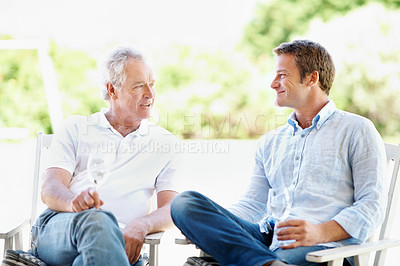 Buy stock photo Drinks, backyard and man with senior father for bonding, conversation and relax on weekend. Family, garden and person with elderly parent, alcohol and wine for connection, relationship and talking