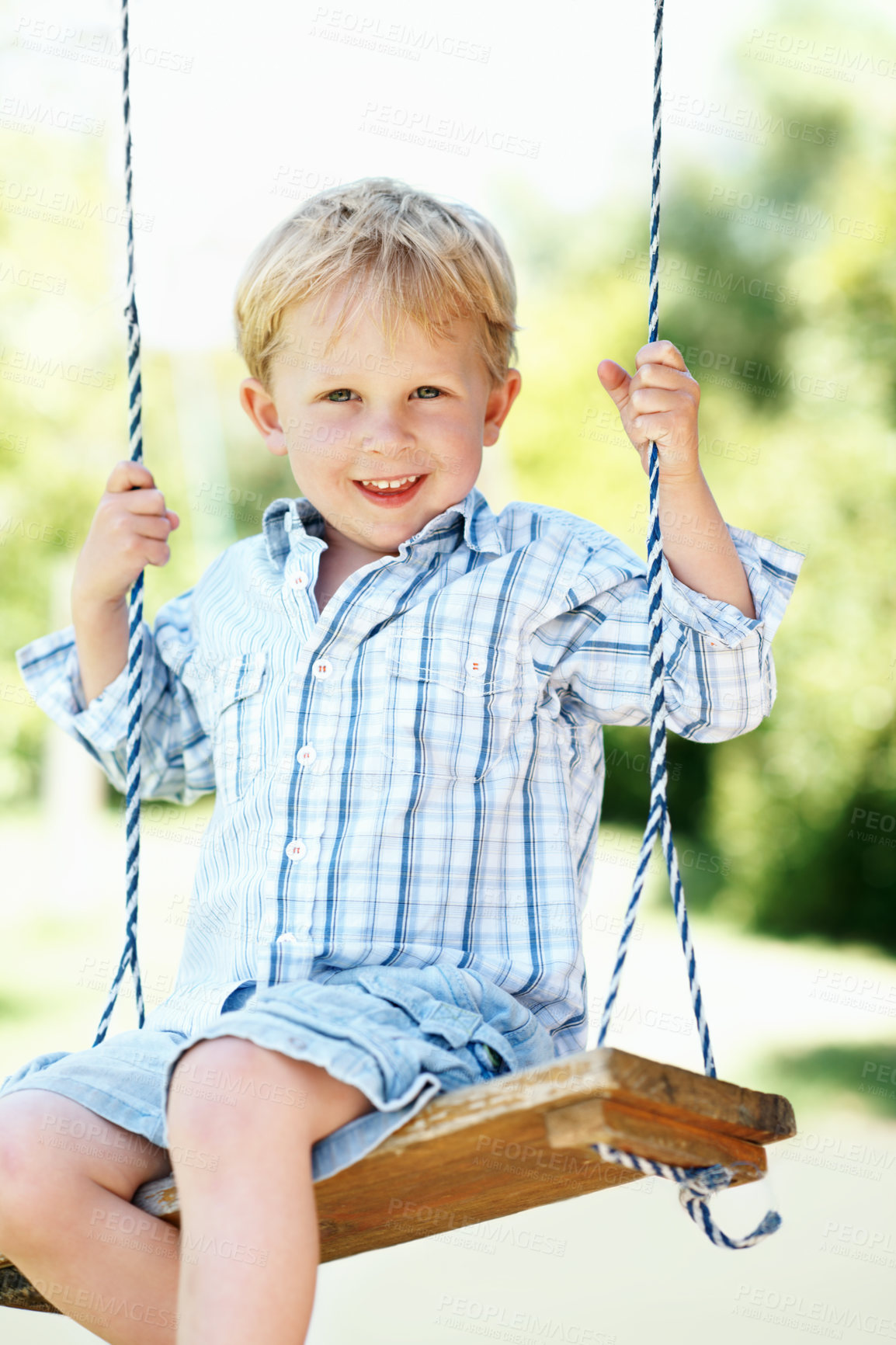 Buy stock photo Happy, portrait and child on swing at park, fine motor skills and development in nature or fresh air. Outdoor, playground and kid with smile on weekend, growth and boy with positive attitude and fun