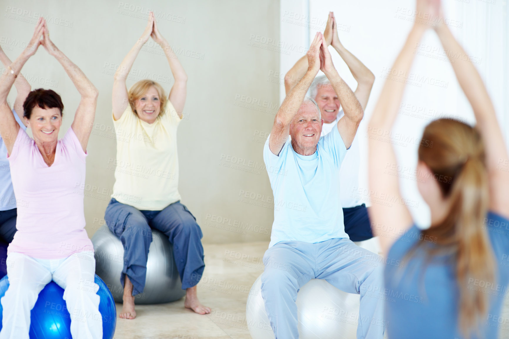 Buy stock photo Group, stretching and instructor in pilates class, fitness and health together for wellness in retirement. Old people, ball or coach with instruction for exercise, movement or smile with support
