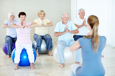 Buy stock photo Coach, yoga and ball with old people for meditation, holistic balance and retirement hobby for zen. Instructor, yogi and namaste pose with senior group for inner peace, spiritual healing and wellness