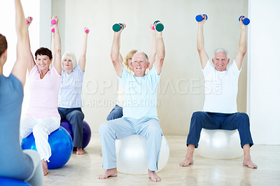 Buy stock photo Dumbbells, exercise and old people with personal trainer in studio for health or wellness. Fitness, retirement and weights with instructor at gym for coaching, physical activity or training class