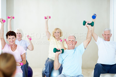 Buy stock photo Dumbbells, exercise and old people in gym class with personal trainer, workout and retirement wellness. Happy, senior group and fitness coach in health club with ball, weights and strength training.