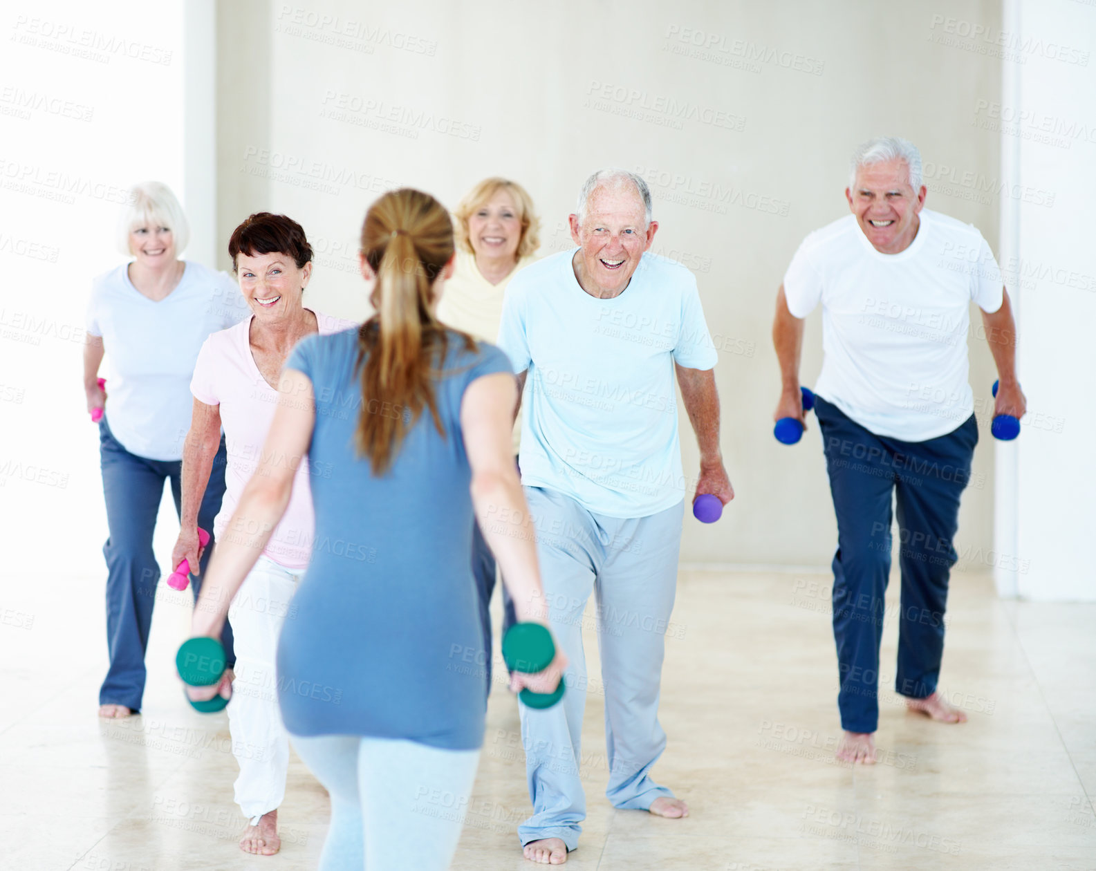 Buy stock photo Dumbbells, class and woman with senior people for exercise, wellness and stretching for mobility. Retirement, gym and trainer with elderly group with weights for health, muscle strength and fitness