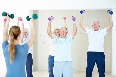 Buy stock photo Weights, class and woman with senior people for exercise, wellness and stretching for mobility. Retirement, gym and trainer with elderly group with dumbbells for health, muscle strength and workout