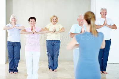 Buy stock photo Yoga class, instructor and senior people with prayer hands for holistic fitness, practice and health. Elderly group, happy yogi and coach with namaste mudra, meditation exercise and wellness club