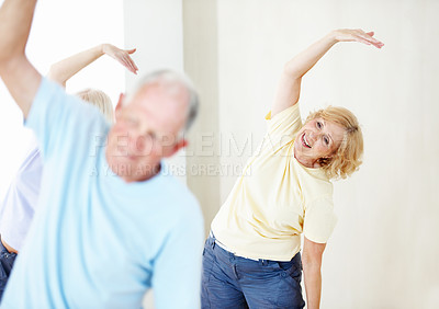 Buy stock photo Pilates, stretching and woman with senior people in studio for fitness, health or wellness. Exercise, happy and smile with elderly group in gym class together for activity, retirement or training