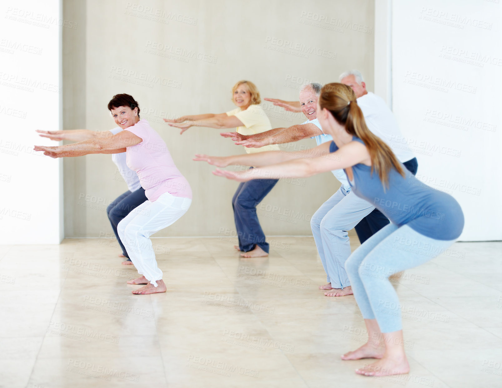 Buy stock photo Senior people, squat and fitness coach in exercise class for balance, wellness and active retirement. Woman, happy group and instructor for teaching, stretching and together for health in old age