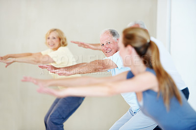 Buy stock photo Happy people, squat and fitness coach in exercise class for balance, wellness and active retirement. Woman, group and instructor for teaching, stretching and together with smile for health in old age