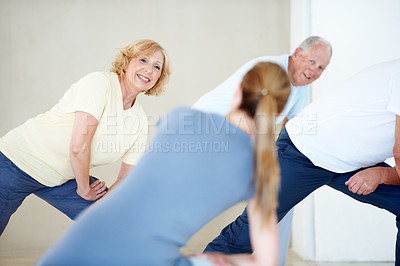 Buy stock photo Fitness class, coach and stretching with senior woman for exercise, health or wellness session. Elderly group, instructor or warm up legs at studio for physiotherapy, training or workout with smile