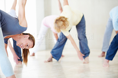 Buy stock photo Woman, stretching and people in class for yoga, fitness and retirement hobby for wellness. Smile, instructor or warm up with senior group for physical therapy, holistic balance and yogi for self care