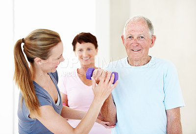 Buy stock photo Pilates, instructor or old man in class with dumbbells, support or fitness in portrait. Senior resident, personal trainer or weights at retirement home for teaching, muscle wellness or exercise group
