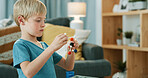 Child, education and serious with molecular model, growth or knowledge with science homework in home. Geometric, development and kid with atom structure for fine motor skills, learning and assignment