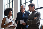 Senior businessman meeting colleagues discussing business documents with boss in office