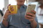 Close up woman hands using smartphone browsing messages on mobile phone drinking coffee