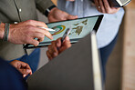 Business people using digital tablet computer with financial data on screen discussing graph information brainstorming marketing strategy in office