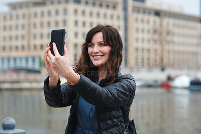 Buy stock photo Travel, happy or woman at harbor with selfie, holiday memory or outdoor post on weekend break. Smile, space or person in town with picture, social media update or sightseeing capture on tourist trip.