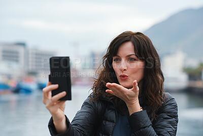 Buy stock photo Blowing kiss, selfie or tourist in town with travel, holiday memory or outdoor post on weekend break. Photo, tourism or woman with playful gesture, social media or sightseeing capture on harbor trip.