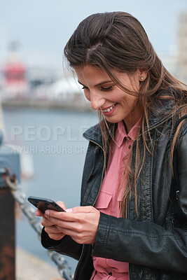 Buy stock photo Travel, smile and woman with phone in harbor with social media post, funny comment and holiday update. Tourist, vacation and person with mobile app for message, joke response and communication
