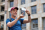 Travel man taking photo using smartphone camera in city tourist sightseeing photographing with mobile phone