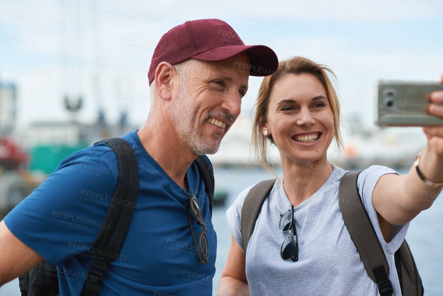 Buy stock photo Couple, travel and selfie in harbor for holiday, date and smile for summer memory or bonding. Mature man, woman and tourist with photography, vacation and together for social media post in waterfront