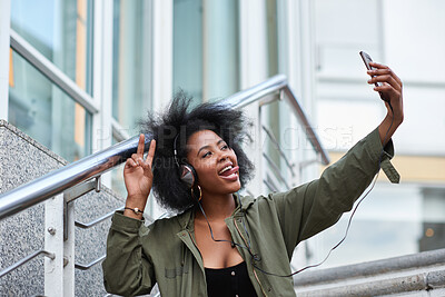 Buy stock photo Headphones, selfie and black woman in city on holiday, getaway or weekend trip for memory with music. Happy, peace sign and female person with audio tech for playlist with photography picture in town