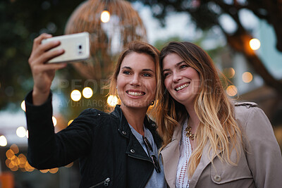 Buy stock photo Selfie, evening and girl friends in city for bonding on holiday, getaway or weekend trip with memory. Smile, bokeh and women with photography picture for social media on vacation in urban town.