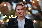 Portrait beautiful blonde woman smiling happy in city evening with lights in background
