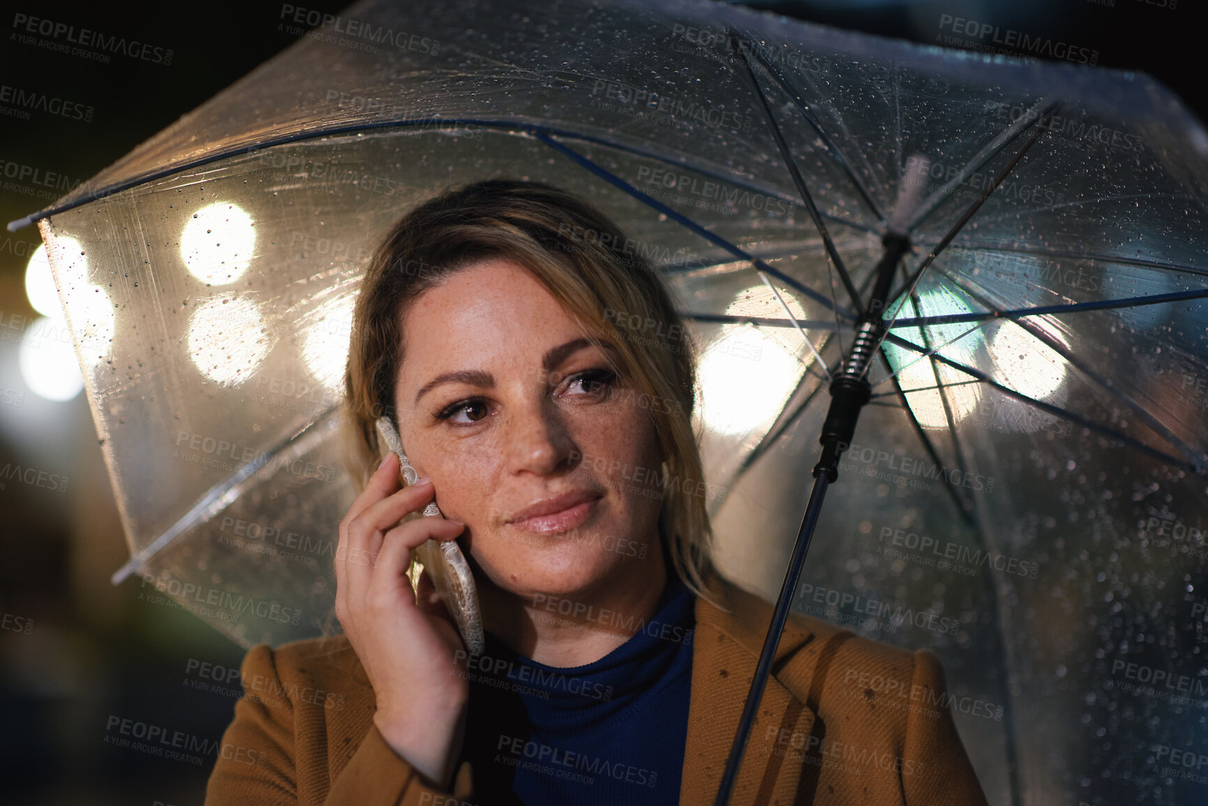 Buy stock photo Outdoor, umbrella and woman with phone call at night, digital communication and commute for networking. Smile, rain and calm person with mobile for online conversation, bokeh and late travel in city