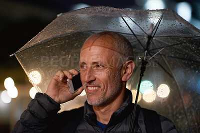 Buy stock photo Outdoor, umbrella and man with phone call at night, digital communication and commute for networking. Smile, rain and mature person with mobile for online conversation, bokeh and late travel in city