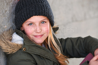 Buy stock photo Portrait, kid and winter vacation by wall with smile for development, growth and relax outdoor. Happy, cute child and beanie for cold weather, travel and tourist girl on holiday in Switzerland