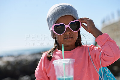 Buy stock photo Outdoor, sunglasses and girl with milkshake for holiday, winter outfit and travel destination for trip. Space, shades or child with tumbler cup for vacation, nature or stylish accessories for weekend