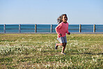 Little girl running in park by seaside playful child enjoying childhood freedom