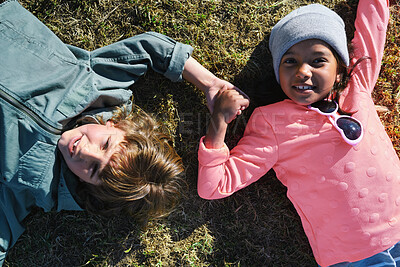 Buy stock photo Relax, holding hands and portrait of children in nature with bonding on holiday, getaway or vacation. Happy, kids and friends laying on grass for connection outdoor in park on weekend trip together.