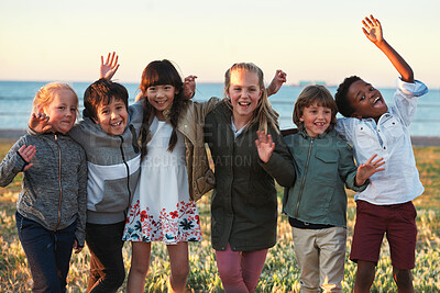 Buy stock photo Portrait, kids and excited by beach with friends, bonding together and hug outdoor for school holiday. Happy, children play and embrace by ocean with development, support and diversity on vacation.