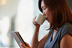 Japanese Businesswoman drinking coffee and working with digital tablet technology