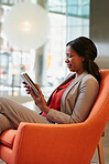 Black Businesswoman working on digital tablet in hotel lobby
