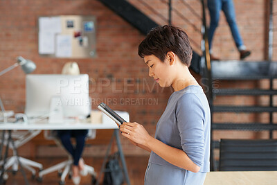 Buy stock photo Business, creative and tablet with designer woman in workplace for planning or research. App, online report and review with design employee in coworking office for administration or email feedback