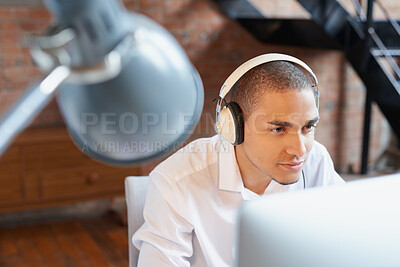 Buy stock photo Business, computer and headphones with designer man in office for planning or research. Music, pc and streaming with design employee in creative workplace for administration or email feedback