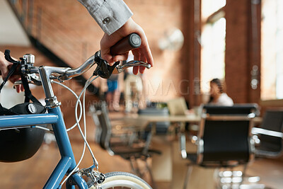 Buy stock photo Business, sustainable and hands in office with bicycle, low carbon and green travel to workplace. Cycling, handlebar and person with bike, eco transport and emission reduction in employee commute.