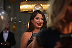 Pretty brunette woman in focus against warm faded evening lights
