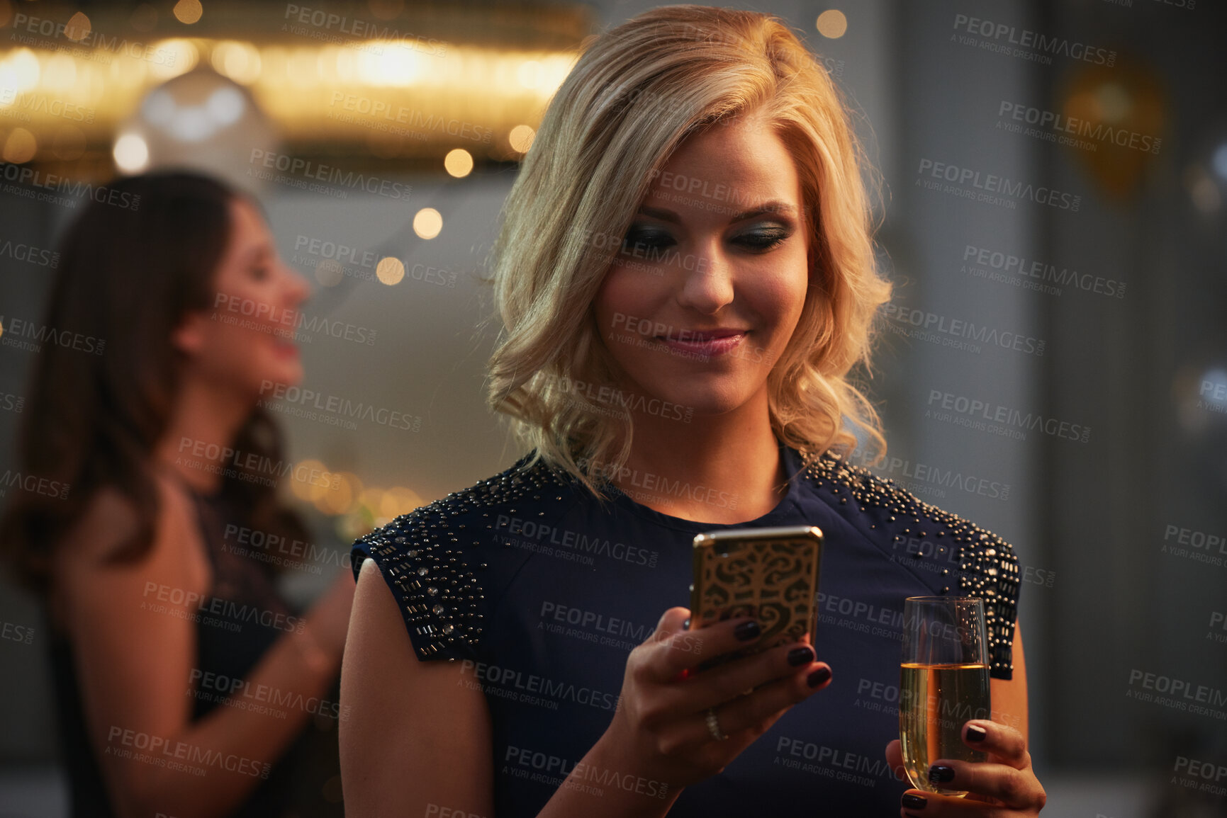 Buy stock photo Phone, champagne and woman at party with social media update, celebration and text message. Mobile, smile and person with alcohol at new year gathering, online connection or gala with bokeh at night