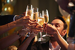 Friends Hands holding up champagne flutes together in a toast at party