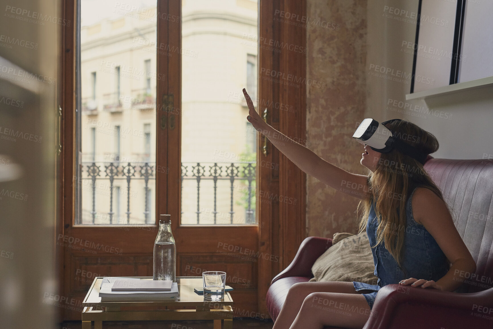 Buy stock photo Woman, touch and vr glasses on home sofa for gaming, virtual reality or futuristic experience. Female person, couch and 3d headset for digital world, technology and interior design app in metaverse