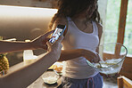 Closeup of Friends having fun making pancakes at home taking photographs with smart phone for social media sharing
